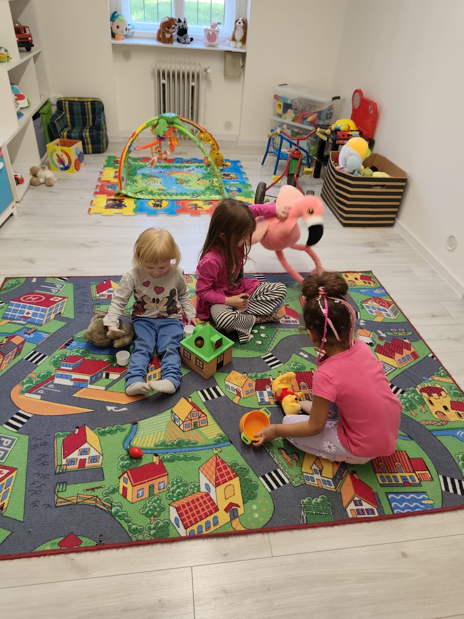 Děti si hrají na herním koberci